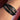 Black leather cross bracelet for men shown on wrist close up