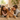 Two children playing with a golden retriever dog in a cozy living room.