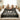 Family holding a decorative blanket with ghost design and text in a bedroom setting
