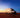White delivery van driving along an open road at sunset, representing fast shipping and nationwide delivery service.