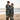 Two people wrapped in a blanket with skeleton design on a beach.