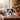 Personalized pet penguin Christmas mug on a cosy festive table beside a Christmas tree, a pet's real face inside a cute cartoon penguin onesie.