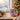 Personalized pet reindeer Christmas mug on a cosy festive table beside a Christmas tree, a pet's real face inside a cute cartoon reindeer onesie.