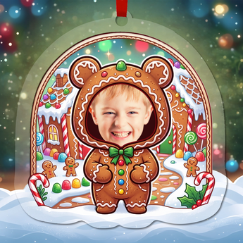 Personalized gingerbread Christmas ornament in clear acrylic — a real photo face on a cute cartoon gingerbread body, on a red ribbon