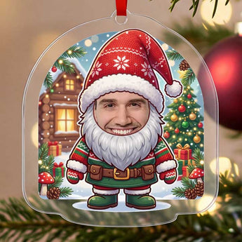 Personalized gnome Christmas ornament in clear acrylic — a real photo face on a cute cartoon Christmas gnome with a big red hat and beard, on a red ribbon
