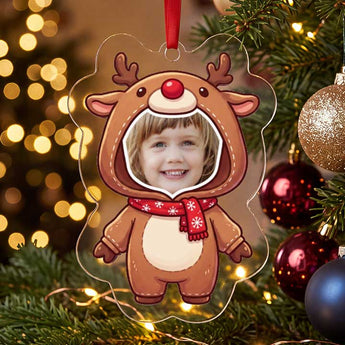 Personalized reindeer photo ornament die-cut to the reindeer shape in clear acrylic — a real face in a cute reindeer onesie, on a red ribbon