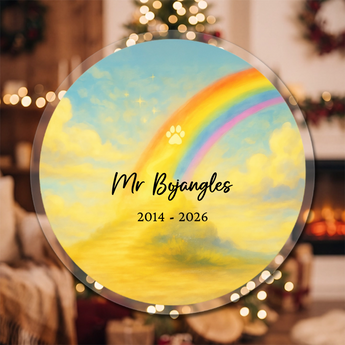 Personalized pet memorial round acrylic ornament with a bright rainbow and golden paw print, engraved with the pet's name and dates