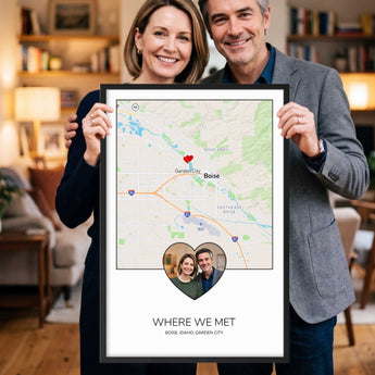 Framed personalized Where We Met photo map print — a couple's photo set inside a heart over a custom street map, with their names and date, in a black wooden frame.