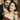 Man giving elegant teardrop pendant necklace to smiling woman during romantic celebration with champagne