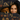 Woman and dog lying under a decorative blanket with Halloween-themed patterns