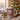 Personalized Santa photo mug on a cosy Christmas table — a real face on a cute cartoon Santa, printed both sides