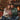 Couple sharing a personalized Lucky in Love necklace gift by the fireplace at Christmas — a romantic keepsake for a wife.