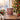 Personalized Christmas pudding photo mug on a cosy Christmas table — a real face on a cute cartoon Christmas pudding onesie with holly, printed both sides