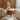 Woman reading a book on a couch with a warm, cozy atmosphere.