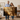 Couple holding 36x24 Christian canvas wall art featuring Jesus the Good Shepherd with a lamb and John 10:11 scripture in a warm farmhouse room.