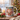 Personalized gingerbread man photo mug on a cosy Christmas table — a real face on a cute cartoon gingerbread onesie, printed both sides