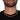 Gold cuban link chain necklace worn by man in black shirt closeup view