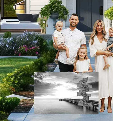happy family with young children and dog standing outside new home holding personalized canvas print with custom name signpost