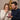 Wife surprised and delighted as her husband gives a personalized Lucky in Love necklace gift — a romantic keepsake for her.
