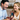 Smiling woman giving a man a luxury watch in a mahogany box with a heartfelt message card inside