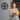 Smiling woman beekeeper standing outside her honey business next to a custom metal sign that reads "Olivia's Honey – EST. 2018" with a bee and honeycomb design – perfect personalized sign for small business branding.