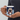 Hand holding a personalized pet penguin Christmas mug so the pet's face design faces out.