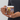 Close-up of a personalized family Christmas mug showing real photo faces on cute cartoon characters in Christmas onesies