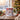 Personalized snowman photo mug on a cosy Christmas table — a real face on a cute cartoon snowman in a top hat and scarf, printed both sides